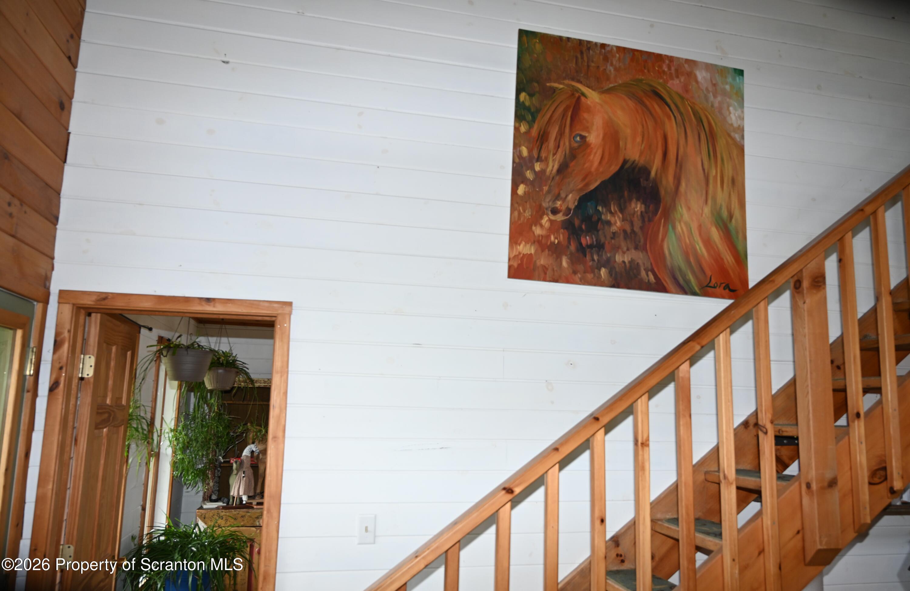 512-318 Johnson Pond Road Montrose, PA 18801 - Photo 75 of 89 a view of staircase with railing and a painting on the wall