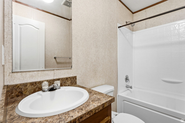 2875 North Hill Field Road, Unit 62 Layton, UT 84041 - Photo 25 of 34 Bathroom featuring a white drop-in sink, a speckled countertop, and a white tub with an integrated shower