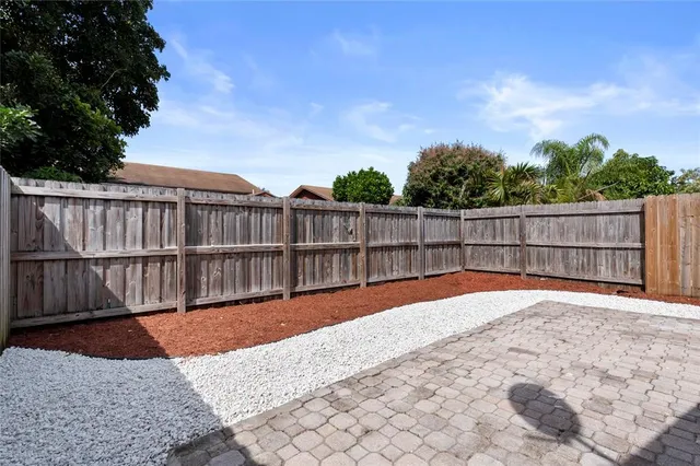 a view of balcony with wooden floor and fence
