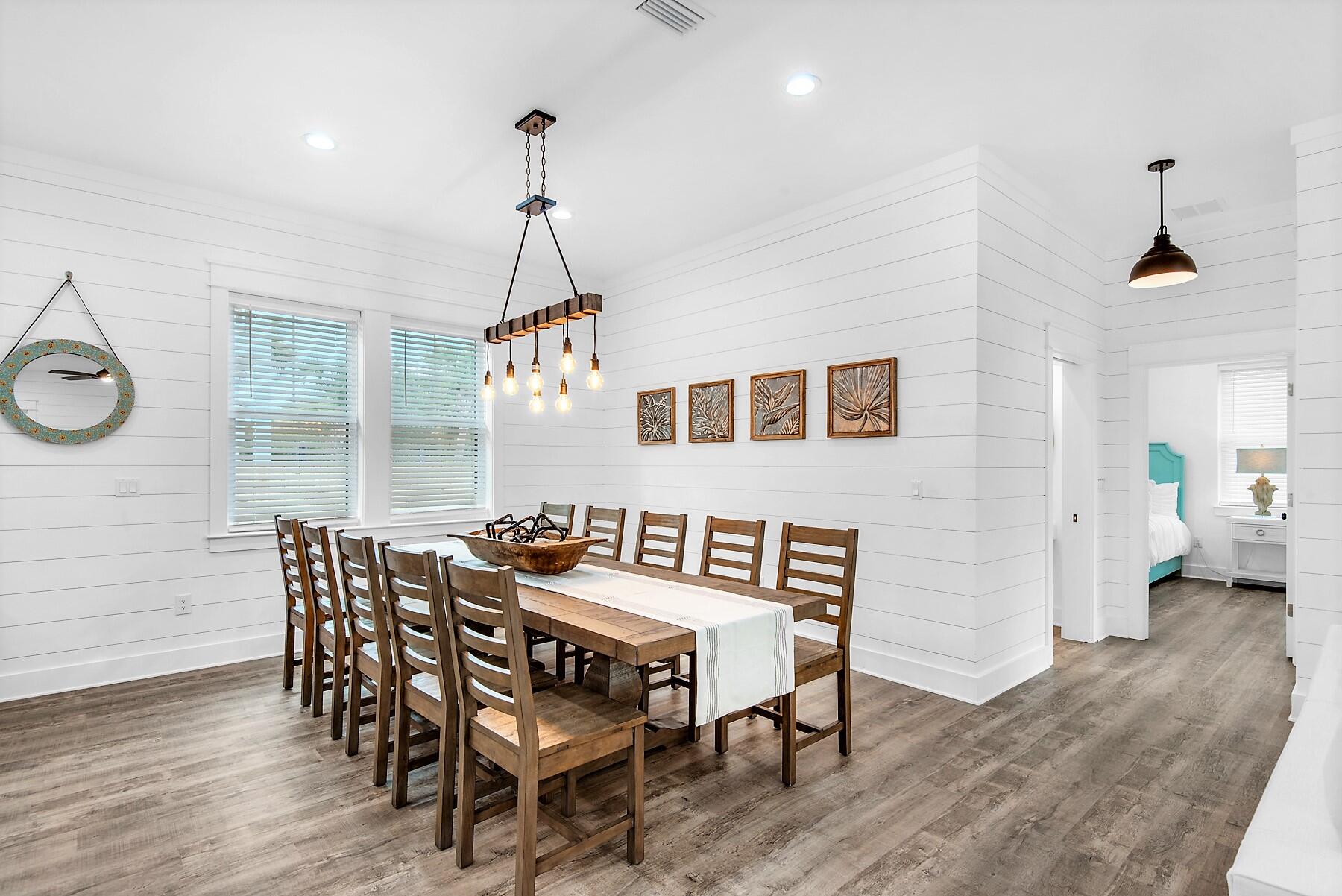 4541 Luke Avenue Destin, FL 32541 - Photo 11 of 49 a dining room with furniture a chandelier and wooden floor
