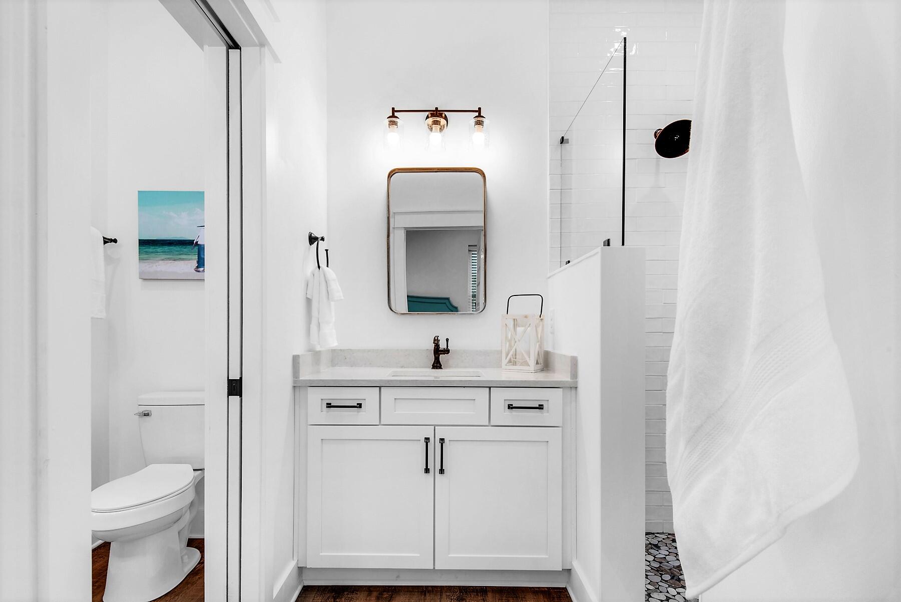 4541 Luke Avenue Destin, FL 32541 - Photo 14 of 49 a bathroom with a sink vanity mirror and toilet