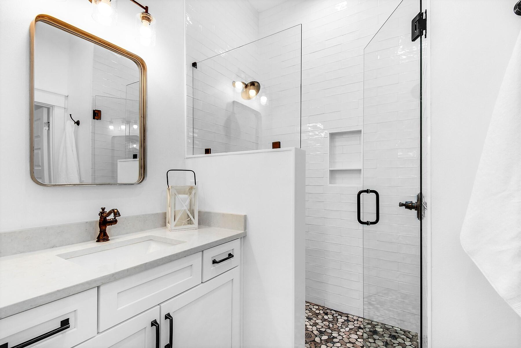 4541 Luke Avenue Destin, FL 32541 - Photo 15 of 49 a bathroom with a shower sink and mirror