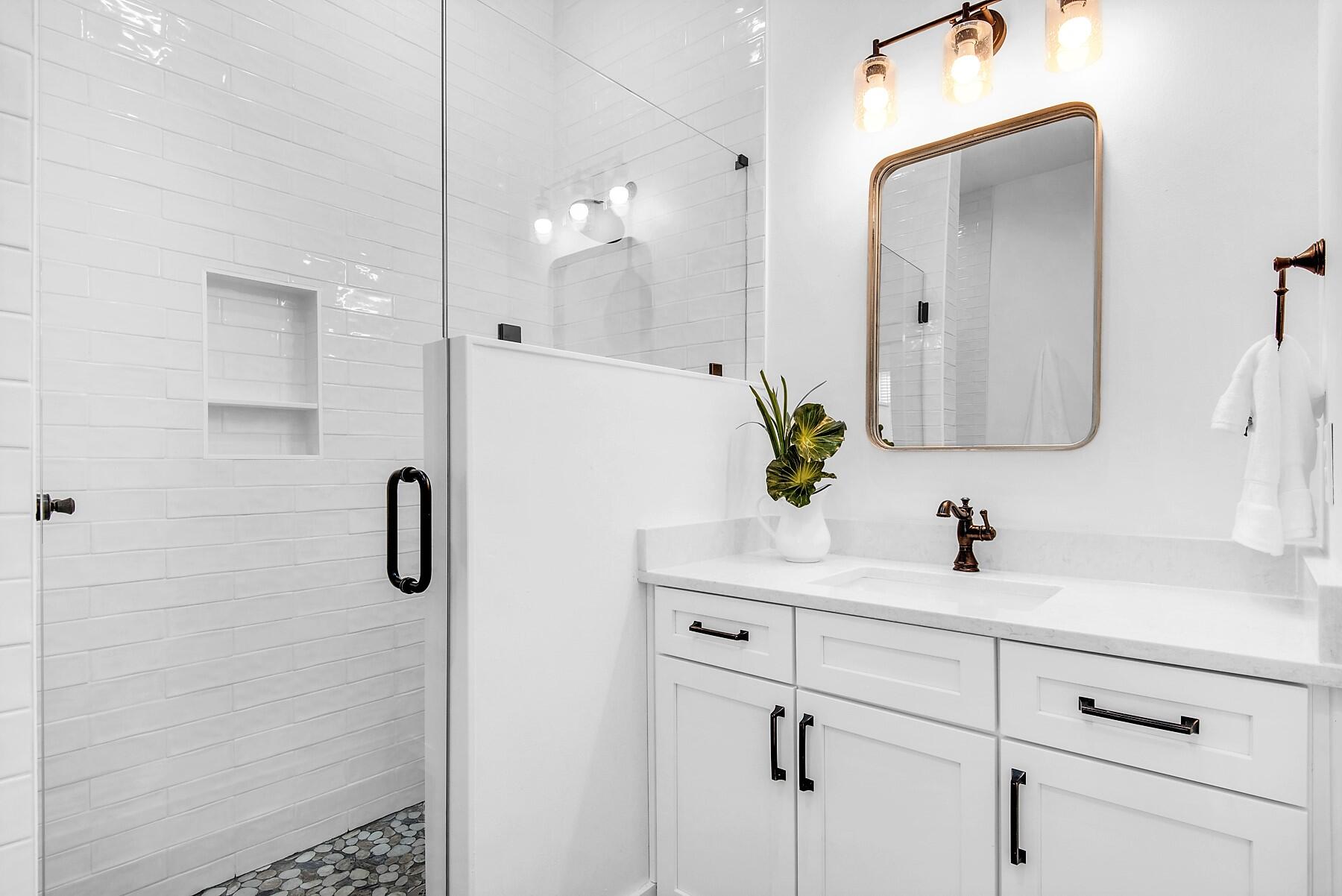 4541 Luke Avenue Destin, FL 32541 - Photo 23 of 49 a bathroom with a sink a mirror and shower