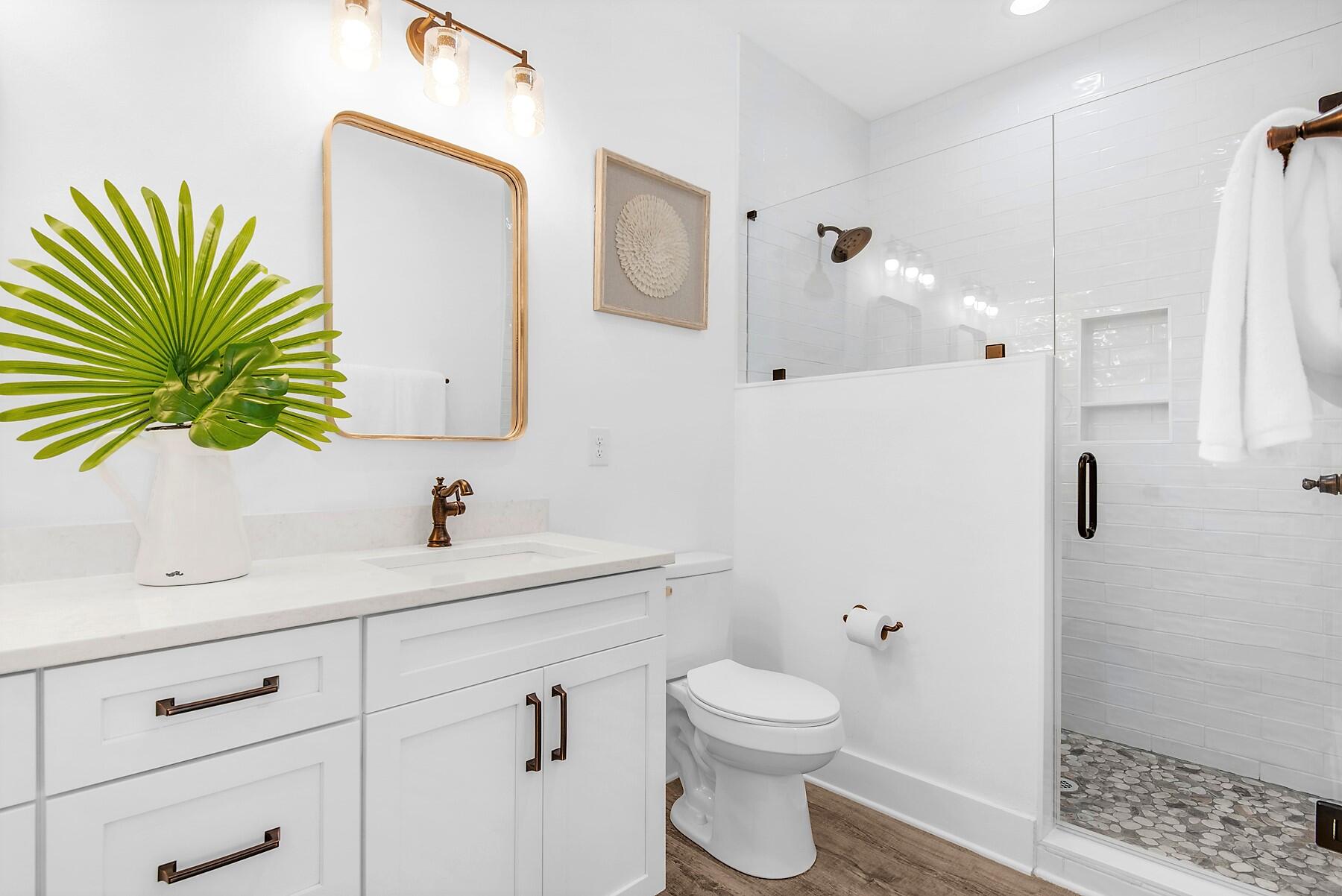 4541 Luke Avenue Destin, FL 32541 - Photo 39 of 49 a bathroom with a sink a toilet and a mirror