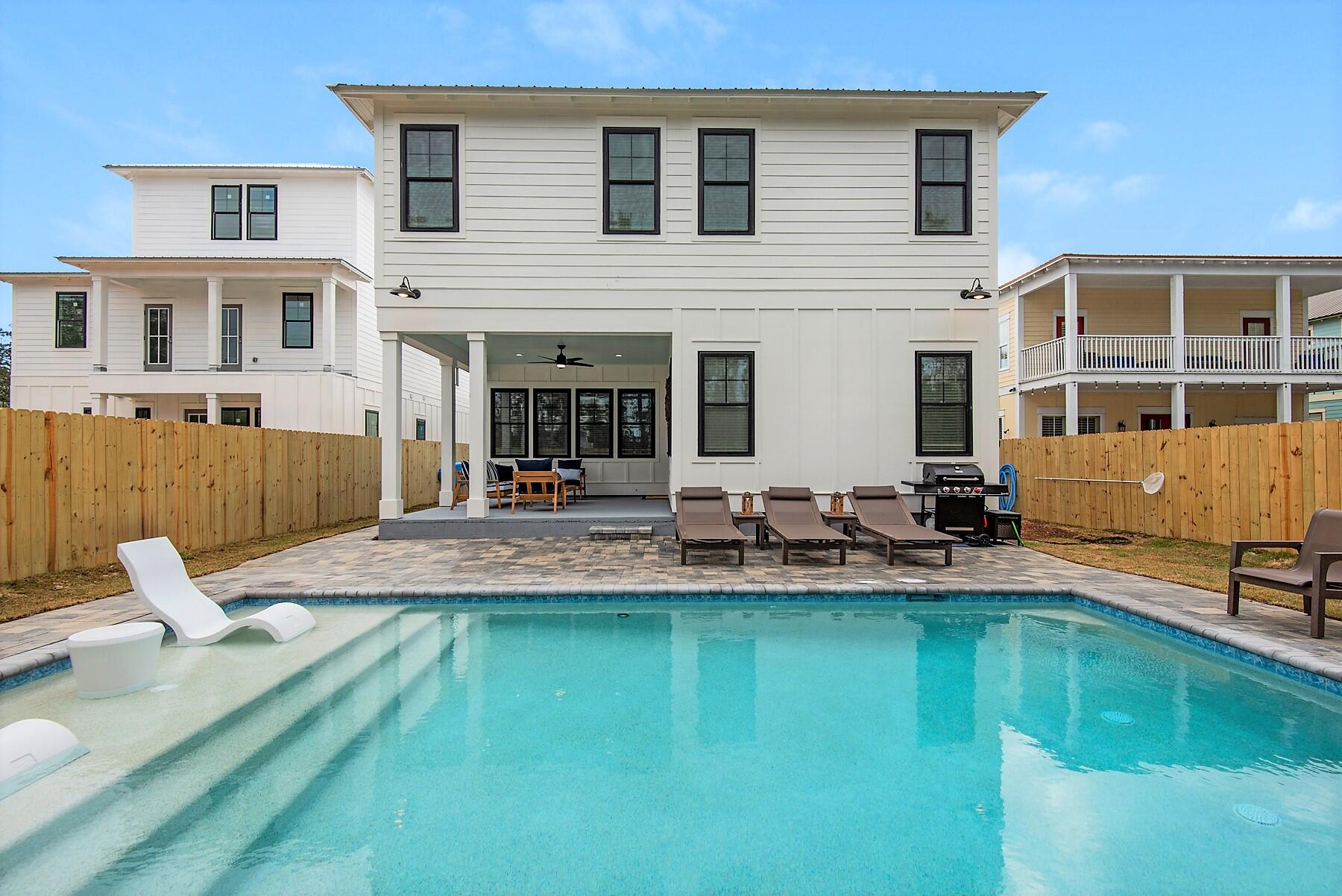 4541 Luke Avenue Destin, FL 32541 - Photo 4 of 49 a view of a house with swimming pool and sitting area