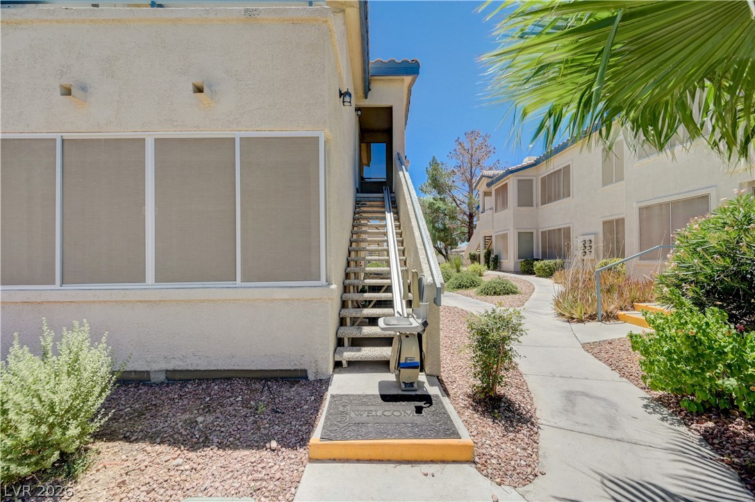 3425 East Russell Road, Unit 223 Las Vegas, NV 89120 - Photo 2 of 47 An inviting exterior path leads to a sun-drenched entrance, showcasing thoughtful landscaping.