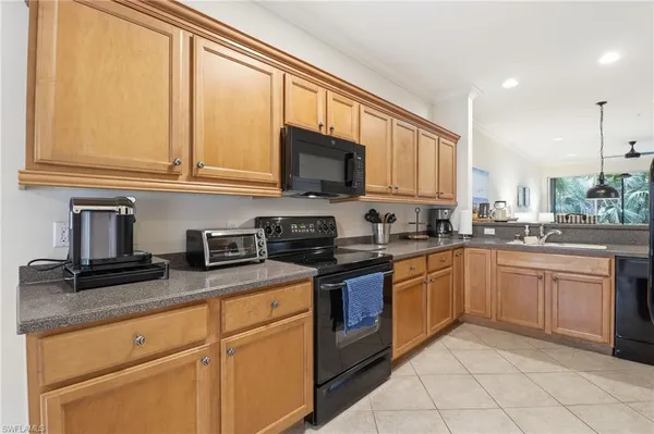 a kitchen with stainless steel appliances granite countertop a refrigerator a sink dishwasher a stove with white cabinets