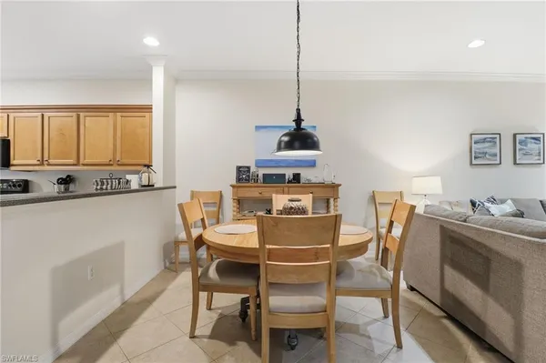 a kitchen with stainless steel appliances kitchen island granite countertop a table and chairs in it