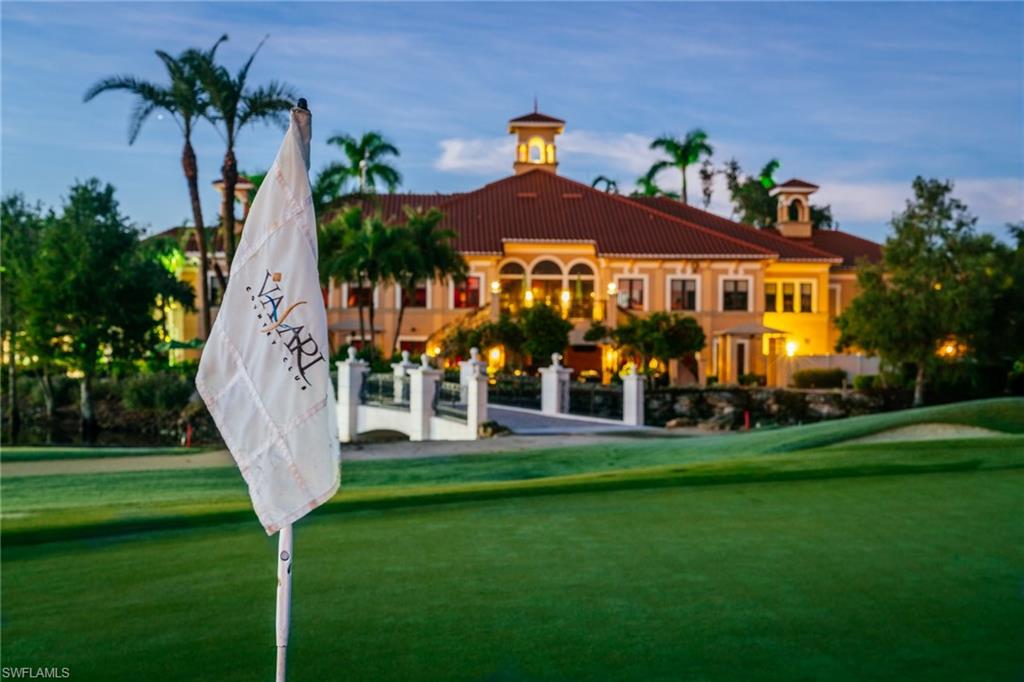 12040 Matera Lane, Unit 104 Bonita Springs, FL 34135 - Photo 2 of 36 a front view of a house with a garden