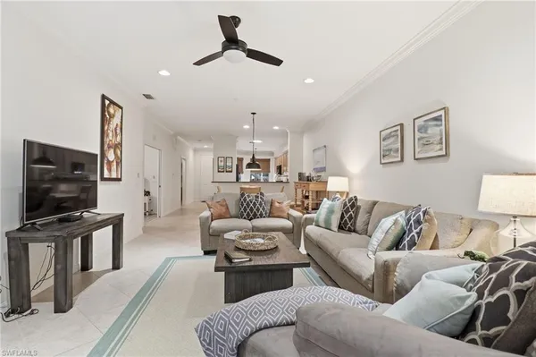 a living room with furniture and a floor to ceiling window