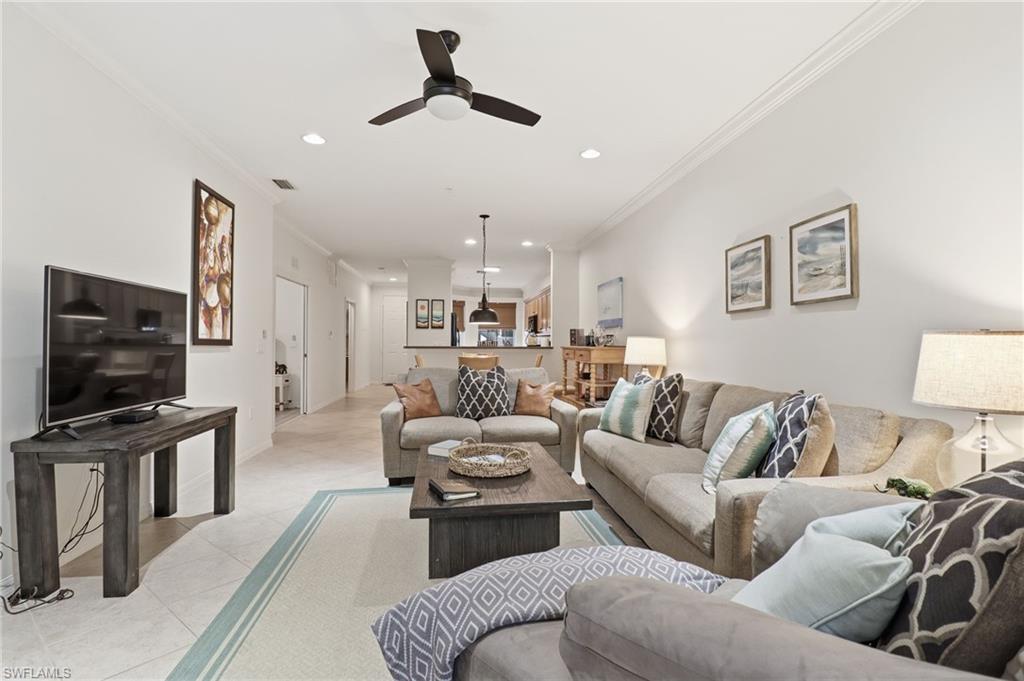 12040 Matera Lane, Unit 104 Bonita Springs, FL 34135 - Photo 25 of 36 a living room with furniture and a flat screen tv