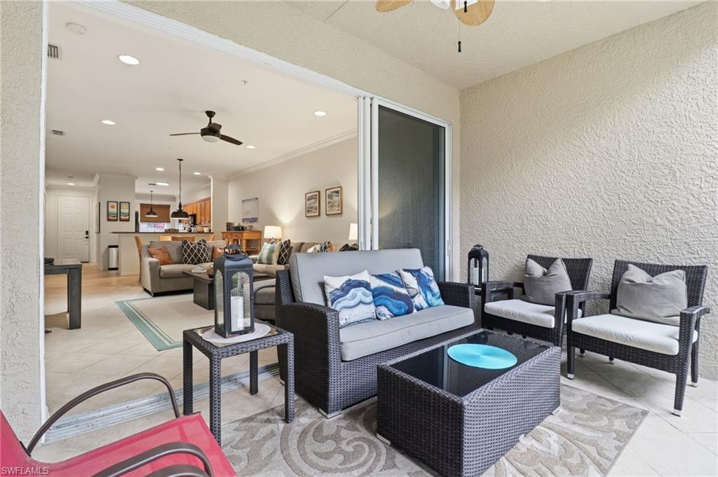 12040 Matera Lane, Unit 104 Bonita Springs, FL 34135 - Photo 27 of 36 a living room with furniture and view of kitchen