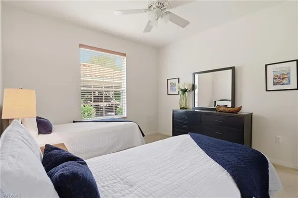 a bedroom with two beds and a night stand