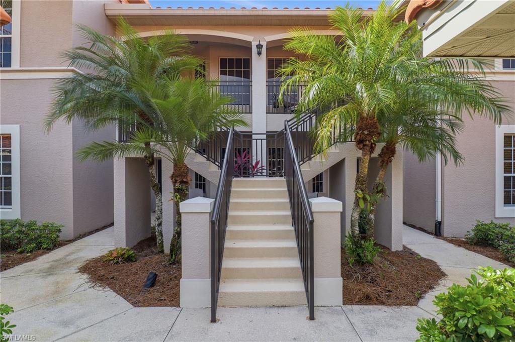 12040 Matera Lane, Unit 104 Bonita Springs, FL 34135 - Photo 4 of 36 a front view of a house with a yard