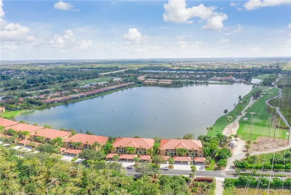 an aerial view of residential building and lake