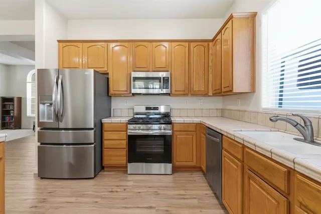 a kitchen with a refrigerator sink and microwave
