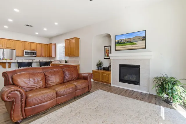 a living room with furniture a fireplace and a potted plant