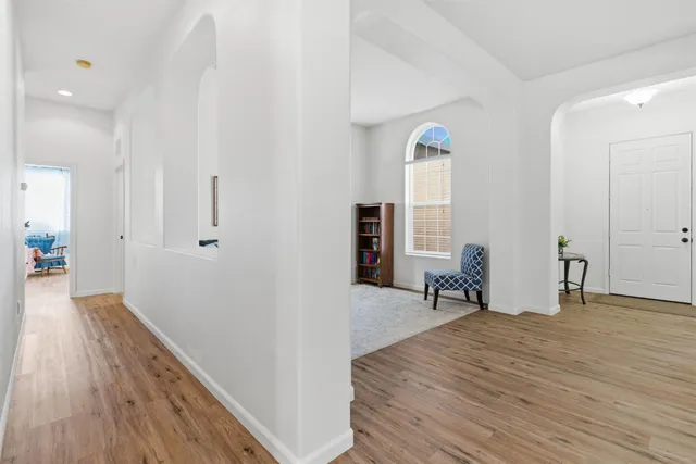 a view of a room with wooden floor and furniture