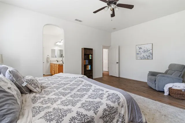 a bedroom with a bed and ceiling fan