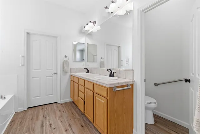 a bathroom with a sink a toilet and a mirror