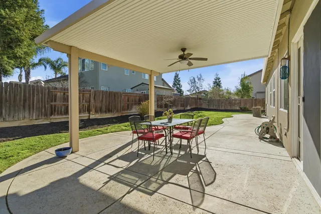 a patio with a yard table and chairs