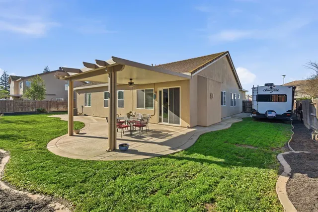 a view of a house with backyard porch and sitting area