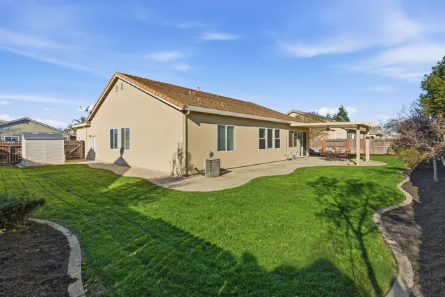 a front view of a house with yard and green space