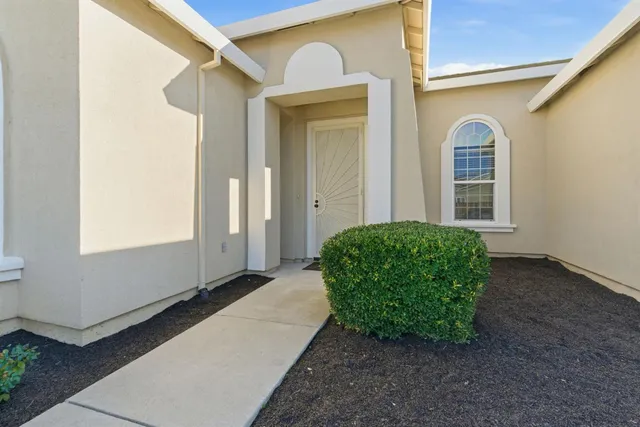 a front view of a house with garden