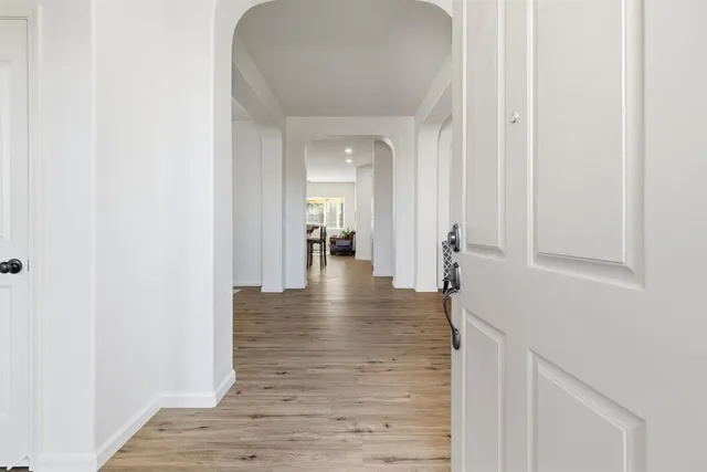 a view of a hallway with wooden floor