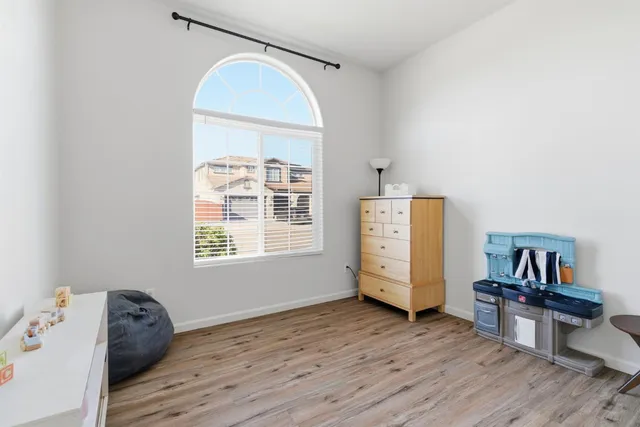 a view of room with window and wooden floor