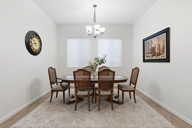 a view of a dining room with furniture and chandelier