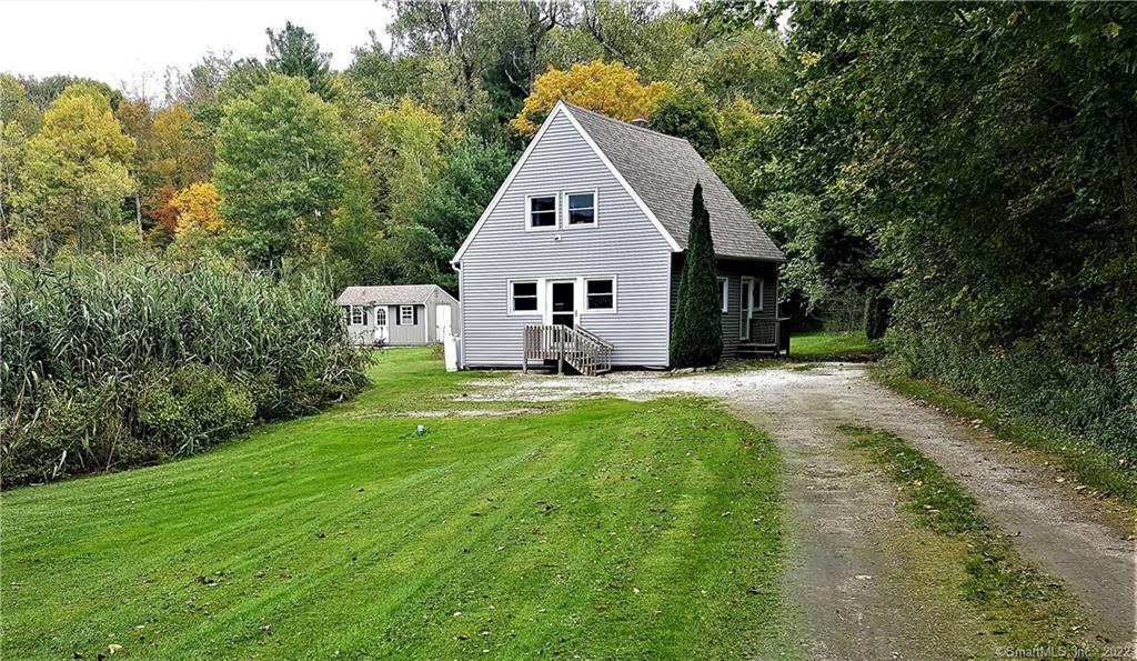 a front view of house with yard and green space