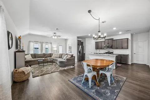 a living room with dining room and kitchen view