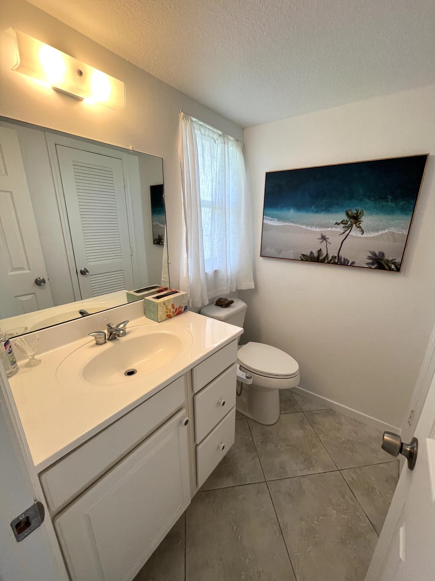 2515 Northeast 1st Court, Unit 411 Boynton Beach, FL 33435 - Photo 11 of 22 a bathroom with a sink and a toilet