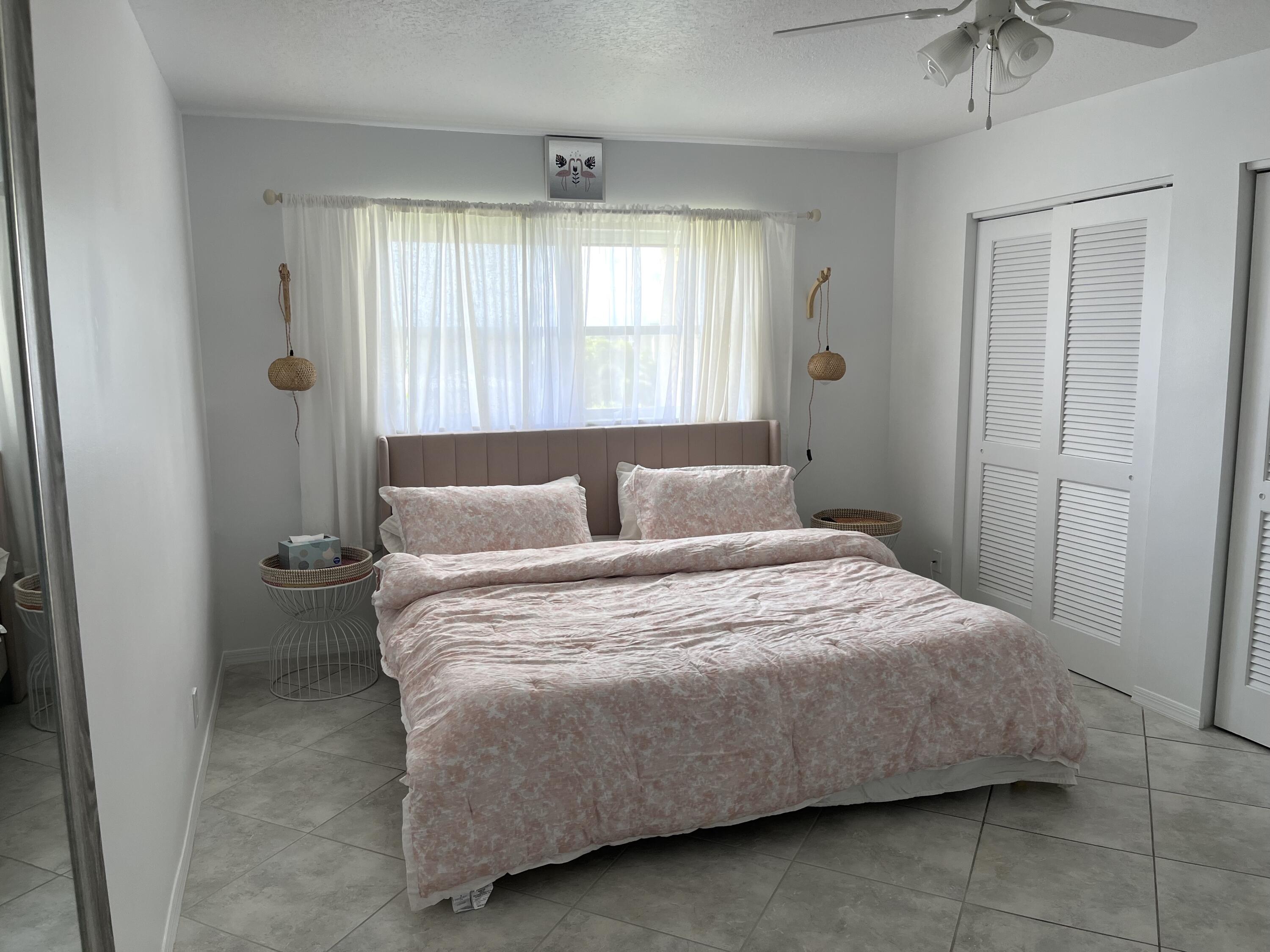 2515 Northeast 1st Court, Unit 411 Boynton Beach, FL 33435 - Photo 12 of 22 a bedroom with a bed and window