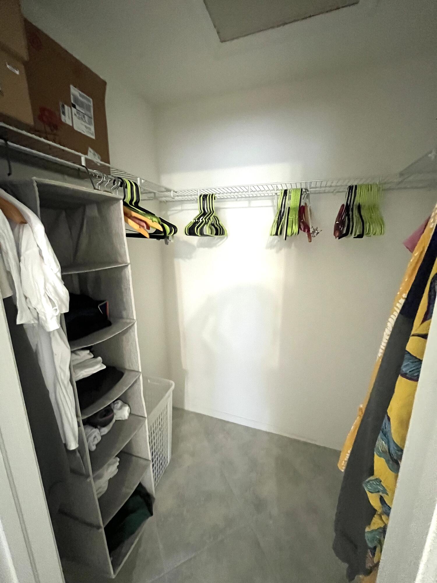 2515 Northeast 1st Court, Unit 411 Boynton Beach, FL 33435 - Photo 14 of 22 a view of walk in closet with clothes and shoes