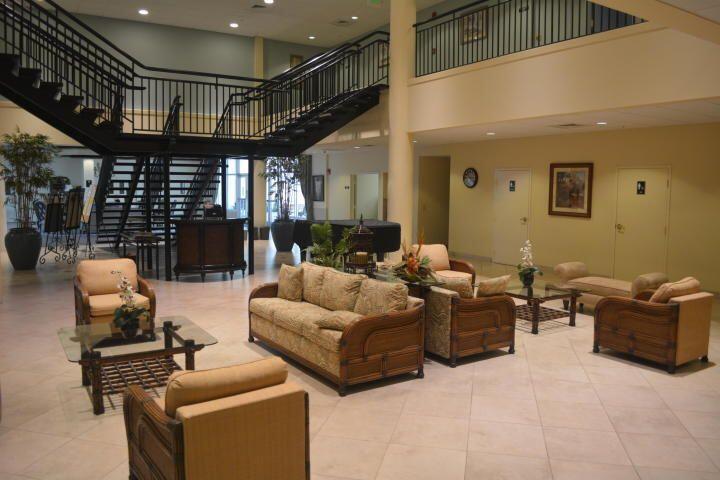 2515 Northeast 1st Court, Unit 411 Boynton Beach, FL 33435 - Photo 18 of 22 a living room with furniture a ceiling fan and a window