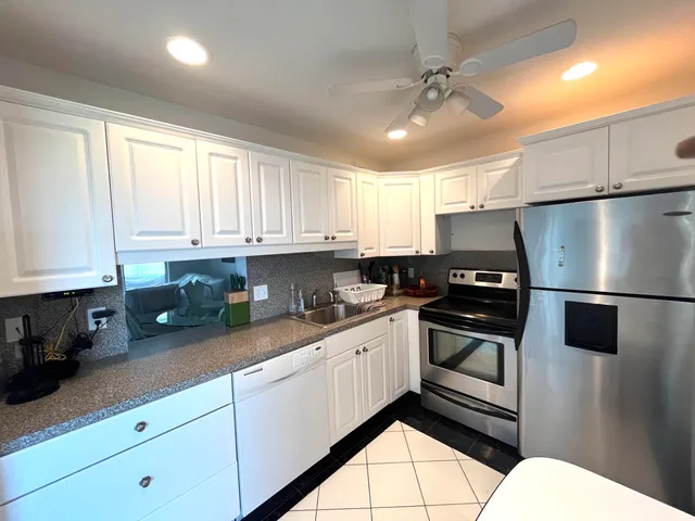 a kitchen with a sink cabinets and stainless steel appliances