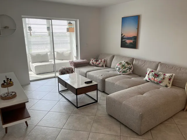 a dining room with furniture and chandelier