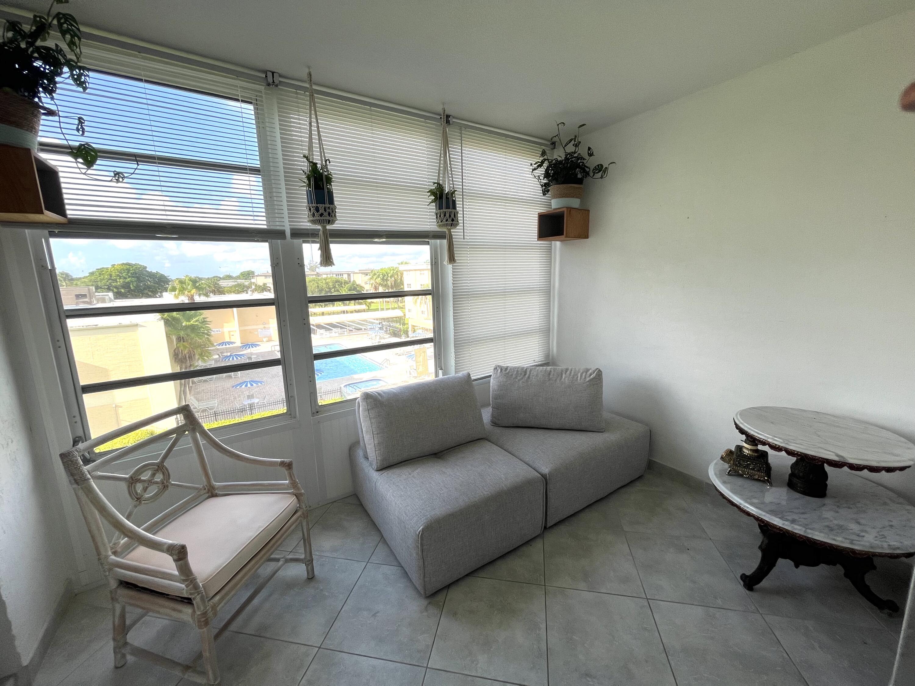 2515 Northeast 1st Court, Unit 411 Boynton Beach, FL 33435 - Photo 8 of 22 a living room with furniture and a window