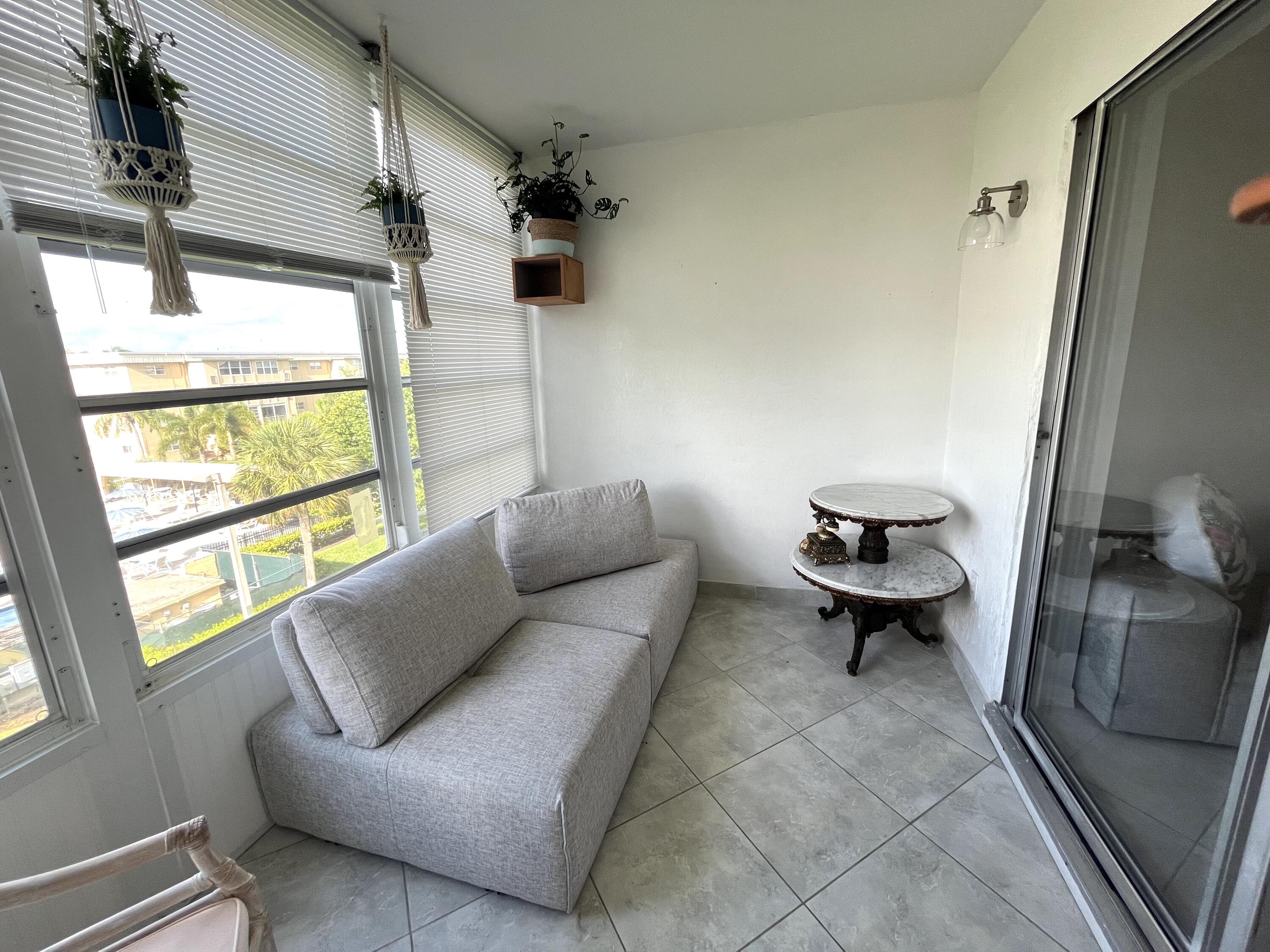 2515 Northeast 1st Court, Unit 411 Boynton Beach, FL 33435 - Photo 9 of 22 a living room with furniture and a window