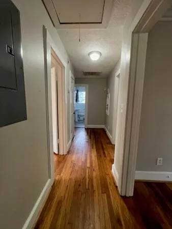 a view of hallway with wooden floor