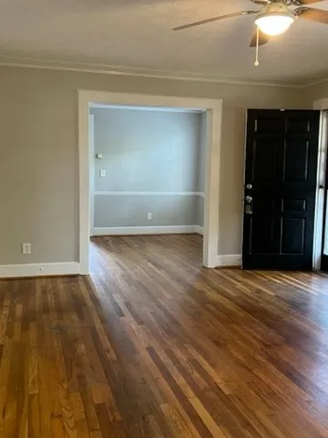 an empty room with wooden floor & closet