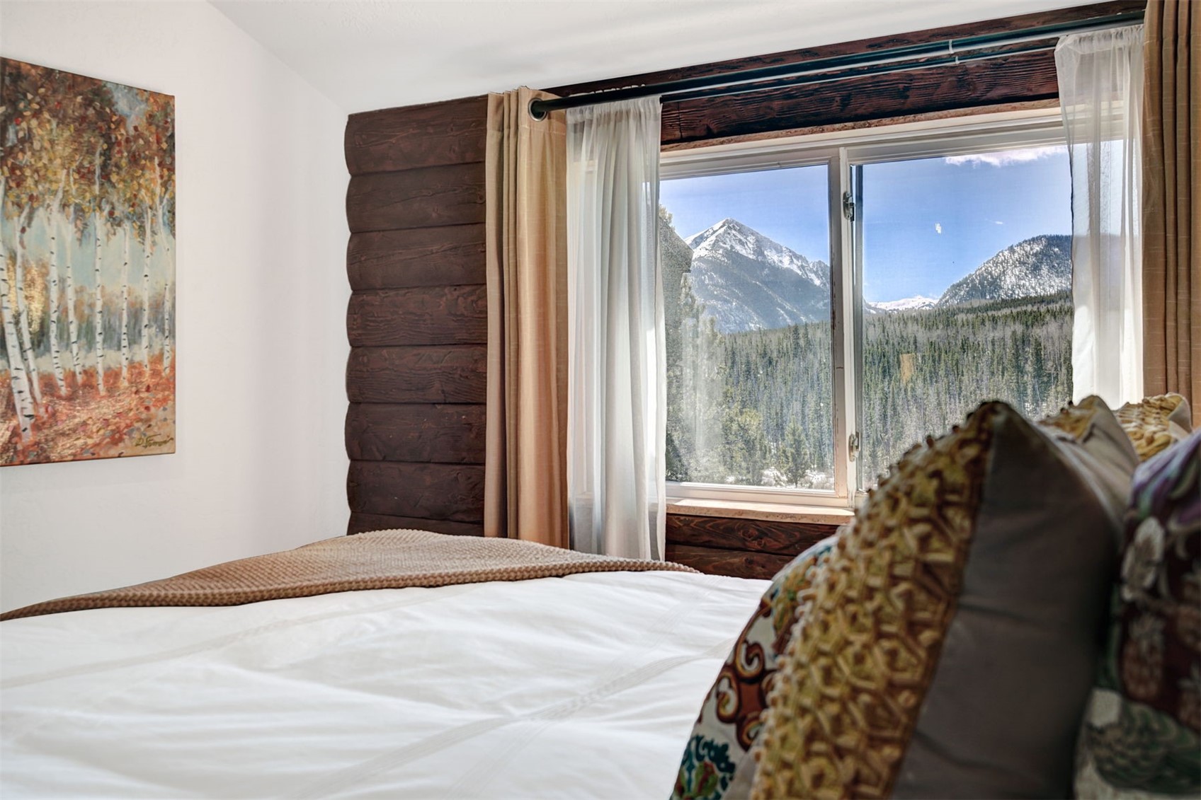 9460 Ryan Gulch Road, Unit 9460 Silverthorne, CO 80498 - Photo 21 of 39 a bedroom with a bed and a large window with balcony view