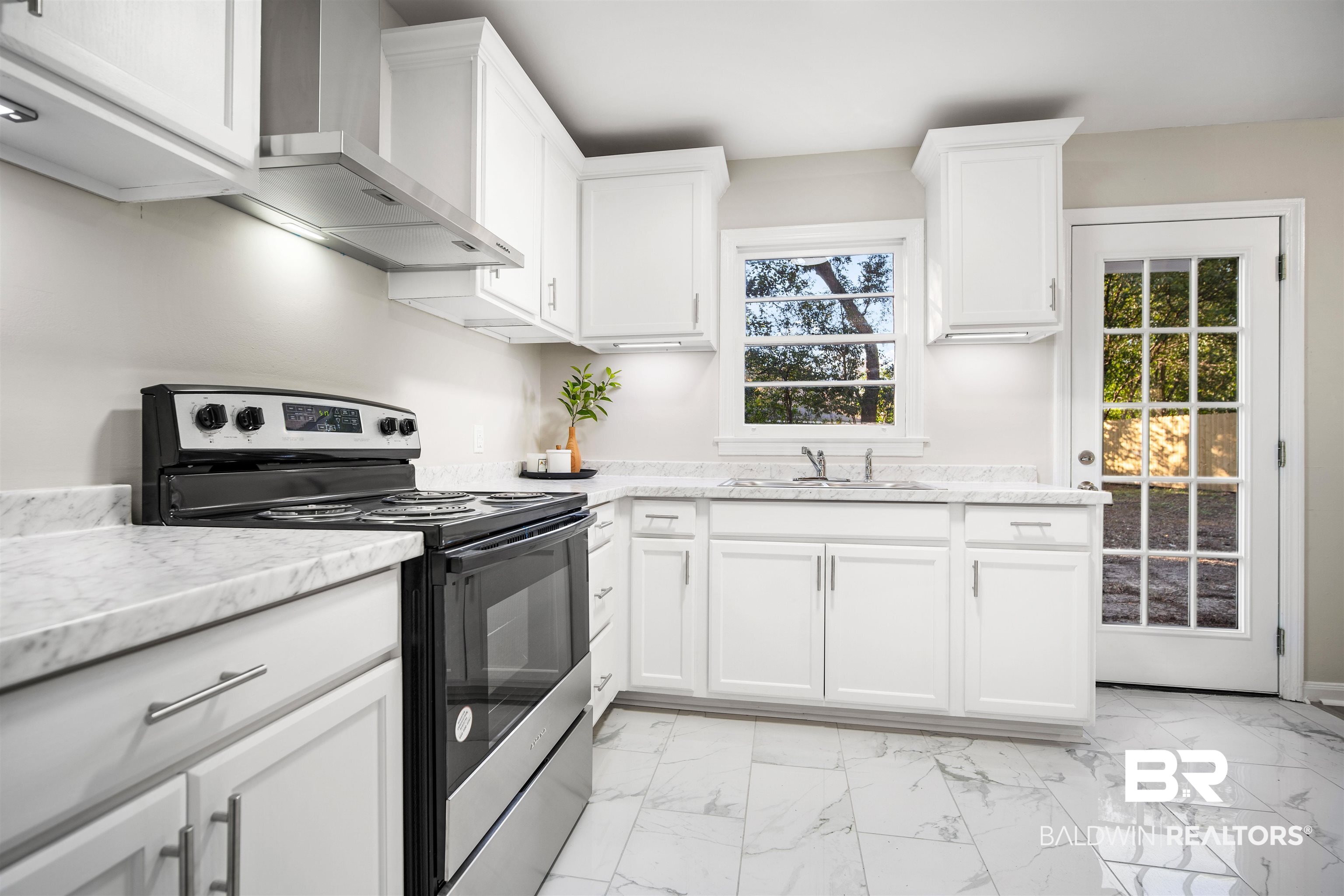662 Merritt Drive Mobile, AL 36609 - Photo 12 of 21 Kitchen featuring a wealth of natural light, sink, wall chimney range hood, electric range, and white cabinets