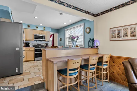 a kitchen with stainless steel appliances a microwave a stove and refrigerator