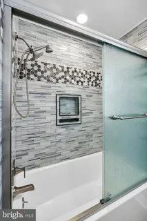a bathroom with a shower and a bathtub