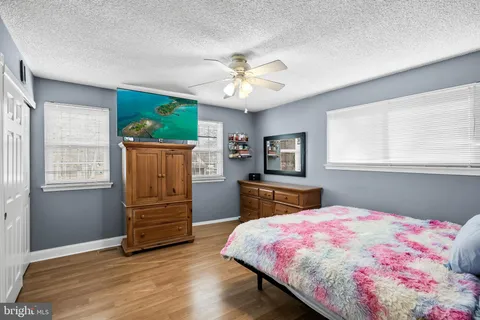 a bedroom with a bed dresser and a window