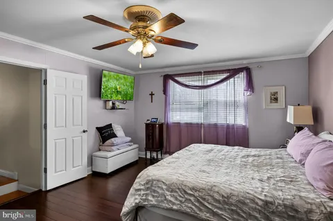 a bedroom with bed and a large window