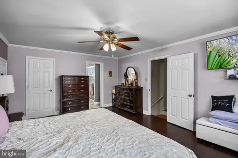 a bedroom with a bed and a television